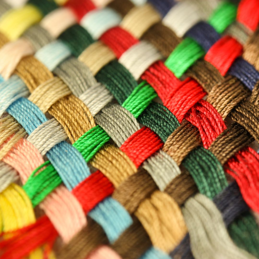 Close-up of multicolor twisted thread, showcasing intricate texture and soft fabric details.